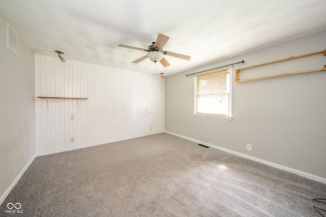2544 N E Raintree Dr, New Castle, IN 47362 - empty room with carpet, a ceiling fan, and wood walls