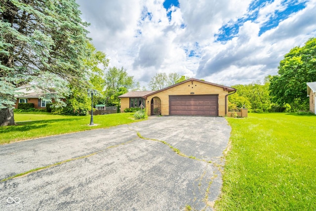 2544 N E Raintree Dr, New Castle, IN 47362 - ranch-style home with driveway, an attached garage, and a front lawn
