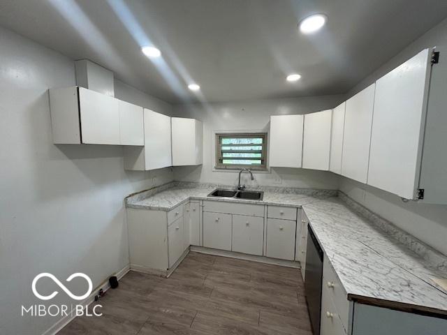 907 Monroe St, Indianapolis, IN 46229 - kitchen featuring a sink, dishwasher, light countertops, white cabinets, and recessed lighting