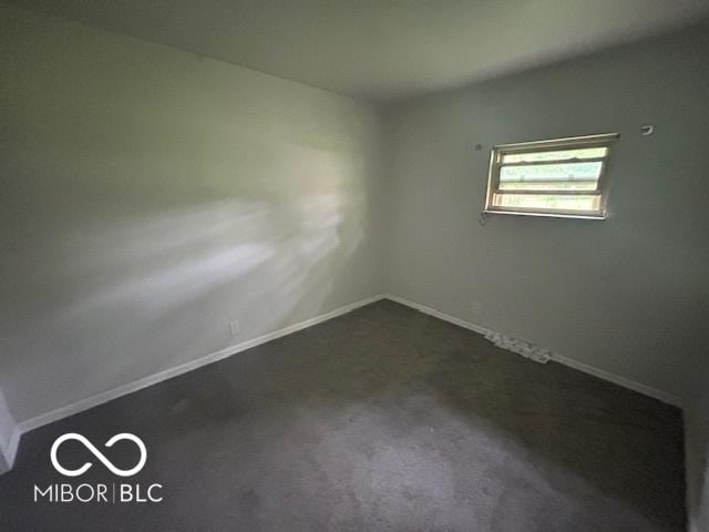 907 Monroe St, Indianapolis, IN 46229 - empty room featuring dark carpet and baseboards