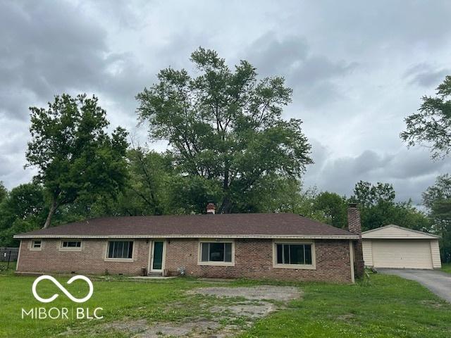 907 Monroe St, Indianapolis, IN 46229 - ranch-style home with a detached garage, a front lawn, brick siding, and an outbuilding