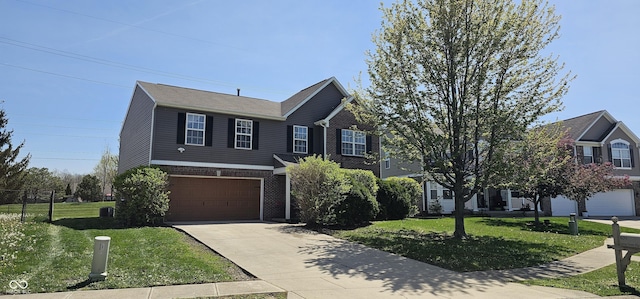 409 Spring Green Pl, Indianapolis, IN 46229 - view of front of house featuring driveway, a garage, a front yard, and brick siding