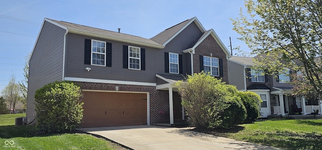 409 Spring Green Pl, Indianapolis, IN 46229 - view of front of house featuring cooling unit, a garage, concrete driveway, and a front lawn
