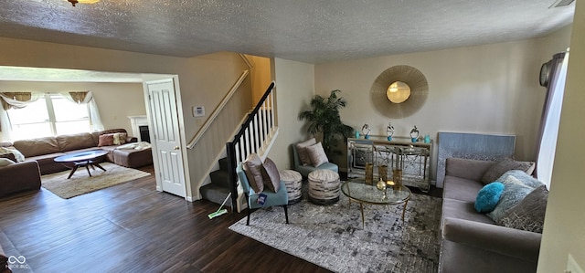 409 Spring Green Pl, Indianapolis, IN 46229 - living room featuring wood finished floors, stairs, a textured ceiling, and a fireplace