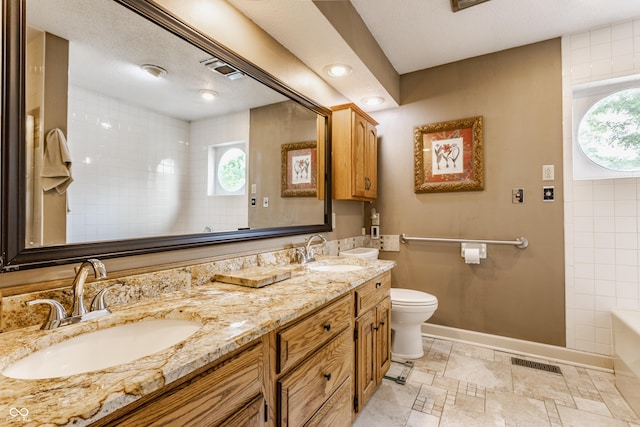 5326 White Marsh Ln, Indianapolis, IN 46226 - bathroom with double vanity, healthy amount of natural light, baseboards, and toilet