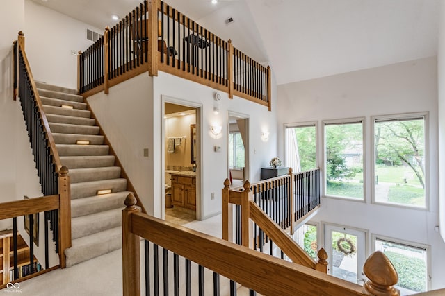 5326 White Marsh Ln, Indianapolis, IN 46226 - staircase with high vaulted ceiling and carpet floors