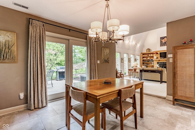 5326 White Marsh Ln, Indianapolis, IN 46226 - dining room featuring healthy amount of natural light, baseboards, a chandelier, and vaulted ceiling