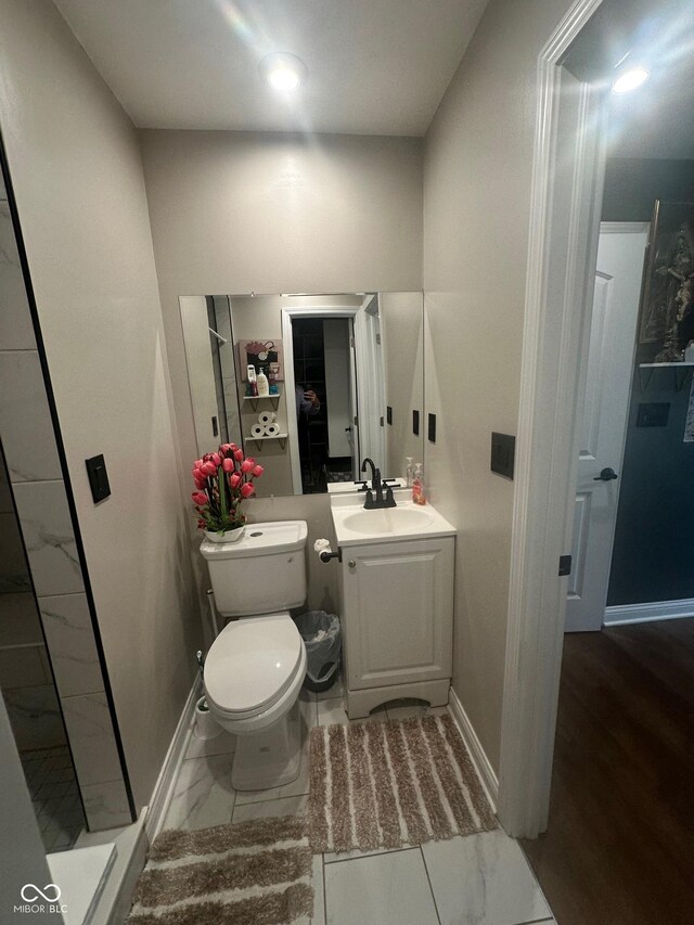 9527 Pepperidge Dr, Indianapolis, IN 46235 - bathroom featuring baseboards, marble finish flooring, vanity, and toilet