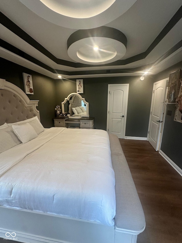 9527 Pepperidge Dr, Indianapolis, IN 46235 - bedroom featuring dark wood-type flooring, baseboards, and a raised ceiling
