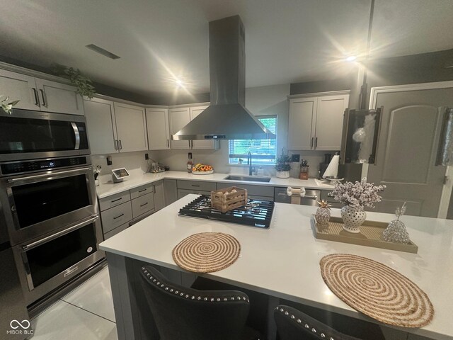 9527 Pepperidge Dr, Indianapolis, IN 46235 - kitchen with island exhaust hood, a sink, appliances with stainless steel finishes, light countertops, and a breakfast bar