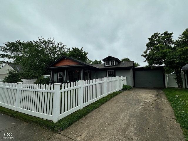 9527 Pepperidge Dr, Indianapolis, IN 46235 - bungalow-style home featuring concrete driveway, a fenced front yard, and an attached garage