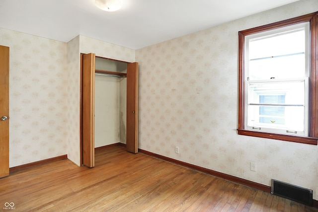 6580 N US Highway 31, Whiteland, IN 46184 - unfurnished bedroom with light wood finished floors, a closet, and baseboards