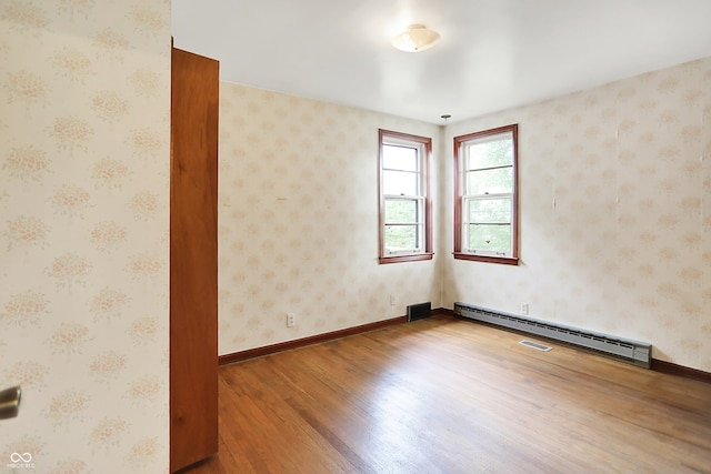 6580 N US Highway 31, Whiteland, IN 46184 - unfurnished room with wood finished floors, baseboard heating, and baseboards