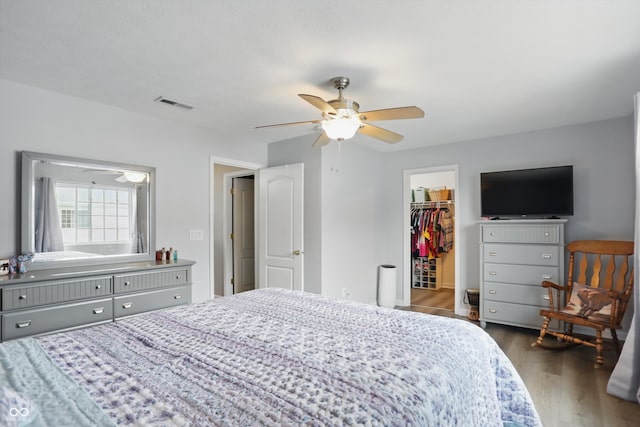 9771 Blue Violet Dr, Noblesville, IN 46060 - bedroom featuring wood finished floors, a walk in closet, ceiling fan, and a closet