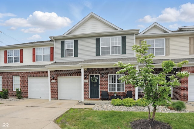 9771 Blue Violet Dr, Noblesville, IN 46060 - townhome / multi-family property featuring driveway, brick siding, and a garage