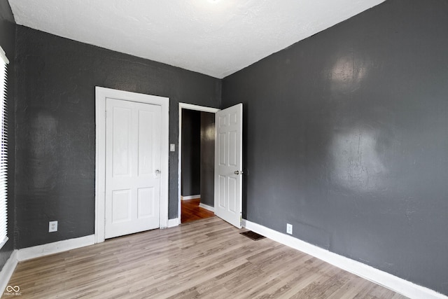 3636 Crescent Ave, Indianapolis, IN 46208 - unfurnished bedroom featuring wood finished floors, baseboards, and a closet