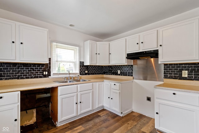 3636 Crescent Ave, Indianapolis, IN 46208 - kitchen featuring a sink, dark wood-type flooring, decorative backsplash, white cabinetry, and under cabinet range hood