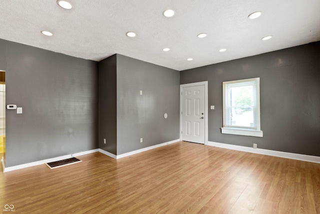 3636 Crescent Ave, Indianapolis, IN 46208 - spare room featuring light wood finished floors, recessed lighting, baseboards, and a textured ceiling