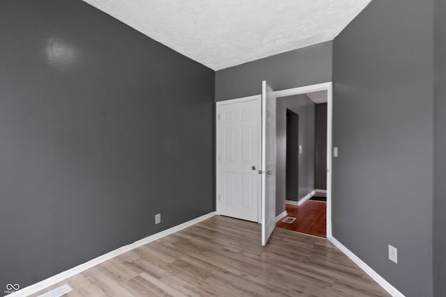 3636 Crescent Ave, Indianapolis, IN 46208 - empty room with a textured ceiling, baseboards, and light wood-type flooring