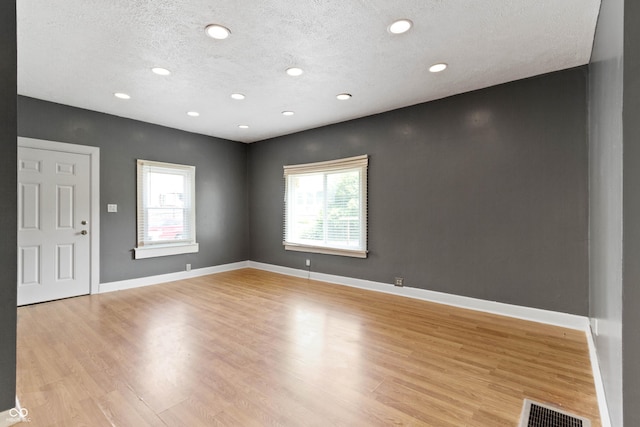 3636 Crescent Ave, Indianapolis, IN 46208 - unfurnished room with plenty of natural light, light wood-type flooring, a textured ceiling, baseboards, and recessed lighting