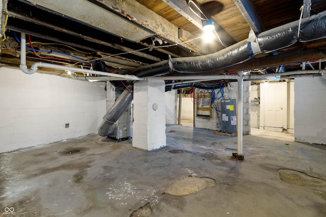 3636 Crescent Ave, Indianapolis, IN 46208 - unfinished basement with electric water heater, concrete block wall, and heating unit