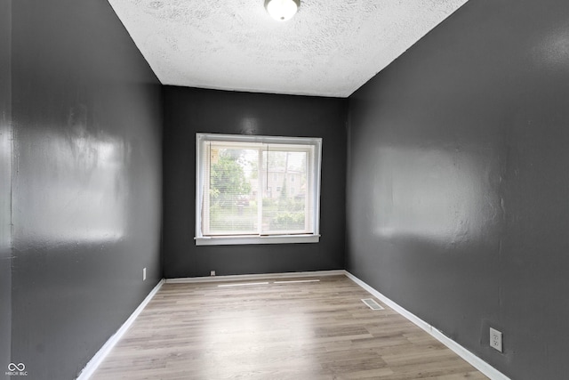 3636 Crescent Ave, Indianapolis, IN 46208 - empty room featuring wood finished floors, a textured ceiling, and baseboards
