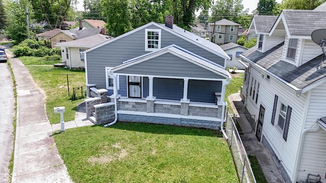 3636 Crescent Ave, Indianapolis, IN 46208 - back of property with a porch, a lawn, and a residential view