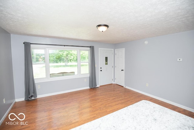 1440 N County Road 275 E, North Vernon, IN 47265 - spare room with a textured ceiling, wood finished floors, and baseboards