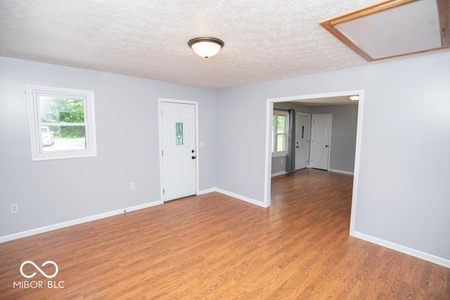 1440 N County Road 275 E, North Vernon, IN 47265 - spare room featuring light wood finished floors, baseboards, and a textured ceiling
