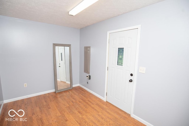 1440 N County Road 275 E, North Vernon, IN 47265 - unfurnished room with light wood-style floors, a textured ceiling, and baseboards