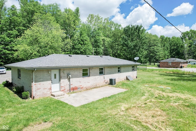 1440 N County Road 275 E, North Vernon, IN 47265 - back of property featuring cooling unit, brick siding, a patio, a lawn, and a shingled roof
