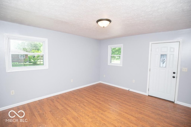 1440 N County Road 275 E, North Vernon, IN 47265 - unfurnished room with wood finished floors, baseboards, and a textured ceiling