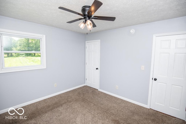 1440 N County Road 275 E, North Vernon, IN 47265 - unfurnished bedroom with carpet flooring, baseboards, a textured ceiling, and ceiling fan