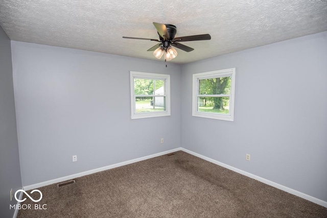 1440 N County Road 275 E, North Vernon, IN 47265 - empty room with ceiling fan, dark carpet, baseboards, and a textured ceiling