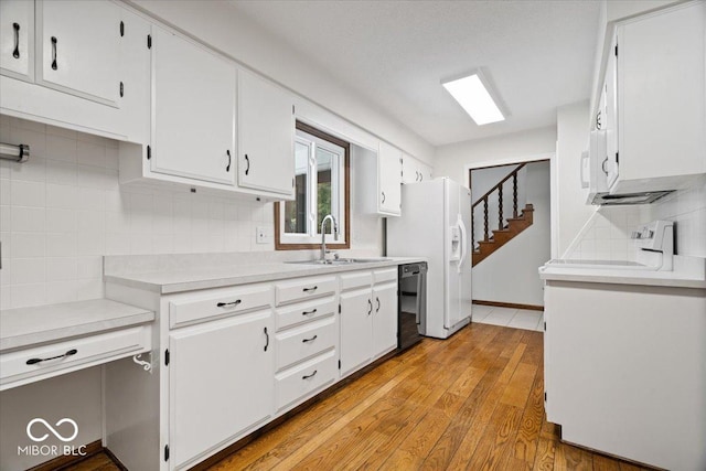 11123 Haverstick Rd, Carmel, IN 46033 - kitchen with dishwasher, range, a sink, light countertops, and white cabinets