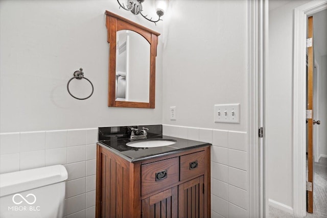 11123 Haverstick Rd, Carmel, IN 46033 - half bath featuring tile walls, vanity, toilet, and wainscoting