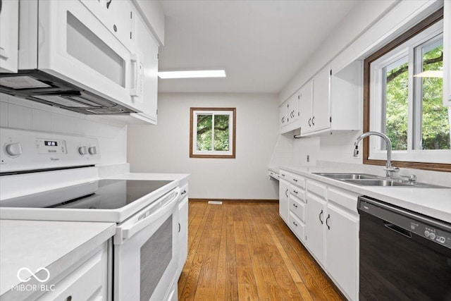 11123 Haverstick Rd, Carmel, IN 46033 - kitchen with white appliances, a sink, light countertops, and healthy amount of natural light