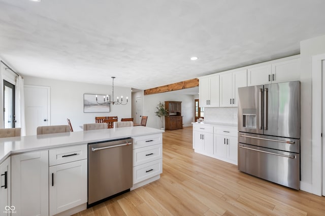10274 S 400 W, Pendleton, IN 46064 - kitchen featuring appliances with stainless steel finishes, plenty of natural light, a chandelier, white cabinets, and recessed lighting