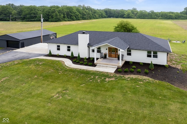 10274 S 400 W, Pendleton, IN 46064 - view of front facade featuring an outdoor structure, a front lawn, a chimney, covered porch, and roof with shingles