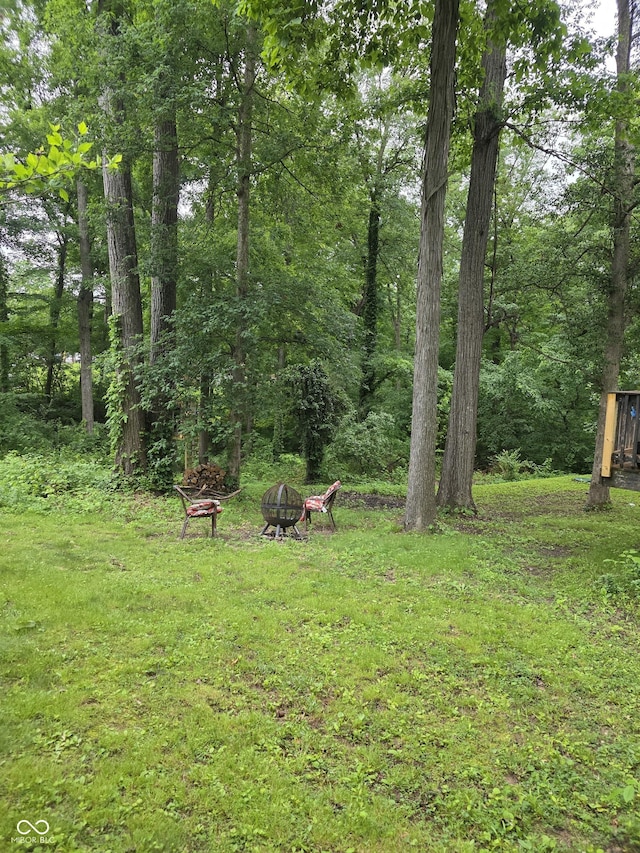 6305 W Hickory Hill Dr, North Vernon, IN 47265 - view of green lawn featuring an outdoor fire pit