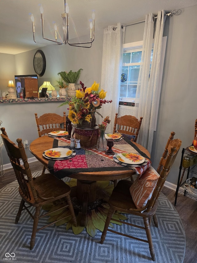 6305 W Hickory Hill Dr, North Vernon, IN 47265 - dining room with wood finished floors, a chandelier, and baseboards