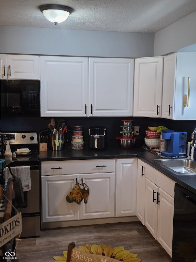 6305 W Hickory Hill Dr, North Vernon, IN 47265 - kitchen featuring black appliances, dark wood-type flooring, a sink, white cabinetry, and a textured ceiling
