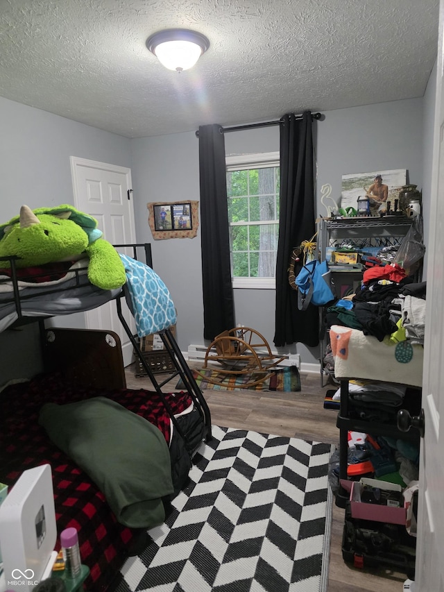 6305 W Hickory Hill Dr, North Vernon, IN 47265 - bedroom featuring a textured ceiling and wood finished floors