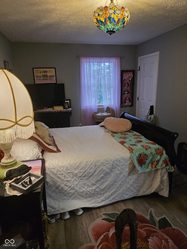 6305 W Hickory Hill Dr, North Vernon, IN 47265 - bedroom featuring wood finished floors and a textured ceiling