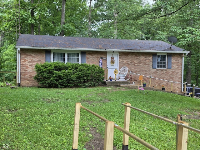 6305 W Hickory Hill Dr, North Vernon, IN 47265 - ranch-style home with a front lawn, brick siding, and roof with shingles