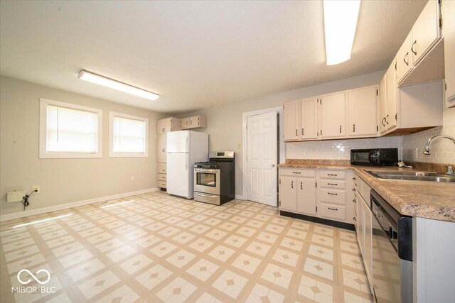 5 E Jefferson St, Maxwell, IN 46154 - kitchen with stainless steel gas stove, freestanding refrigerator, dishwasher, black microwave, and a sink