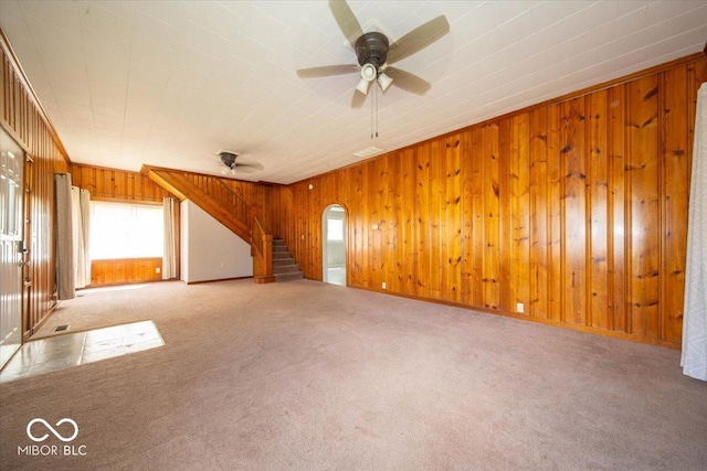 5 E Jefferson St, Maxwell, IN 46154 - unfurnished living room featuring carpet floors, a ceiling fan, wooden walls, and stairway