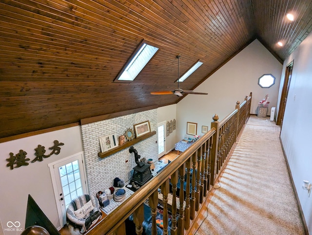 6336 N Carroll Rd, Indianapolis, IN 46235 - hall featuring a skylight, wooden ceiling, high vaulted ceiling, baseboards, and carpet floors