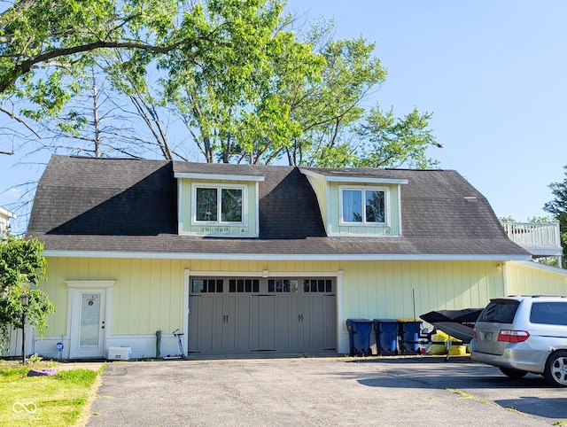 6336 N Carroll Rd, Indianapolis, IN 46235 - view of front of house with a garage, asphalt driveway, and roof with shingles