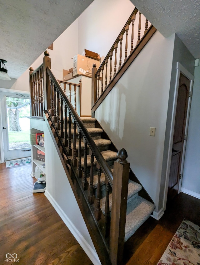 6336 N Carroll Rd, Indianapolis, IN 46235 - stairs with wood finished floors, baseboards, and a textured ceiling